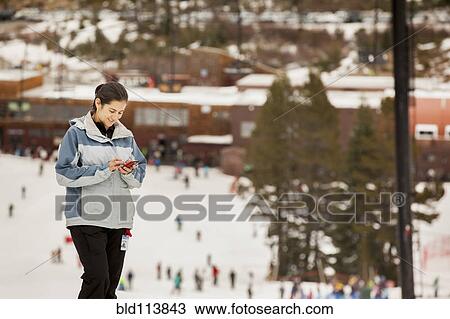 Hispanic girl text messaging on snowy slope View Large Photo Image Stock Image - Hispanic girl text messaging on snowy slope. Fotosearch