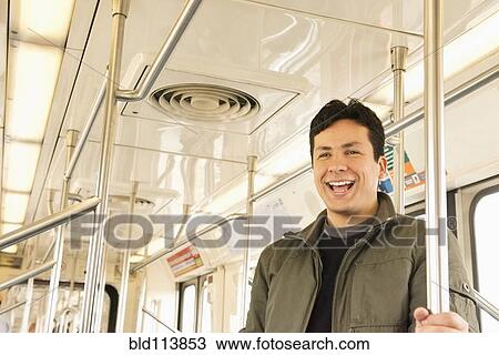 Hispanic man laughing on train View Large Photo Image Stock Image - Hispanic man laughing on train. Fotosearch