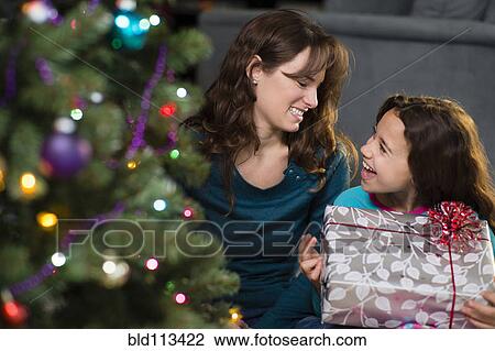 Hispanic mother and daughter opening Christmas presents View Large Photo Image Stock Image - Hispanic mother and daughter opening Christmas presents. Fotosearch