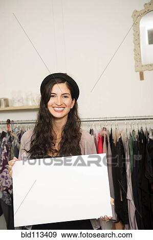 Hispanic woman holding blank card in shop View Large Photo Image Stock Photo - Hispanic woman holding blank card in shop. Fotosearch