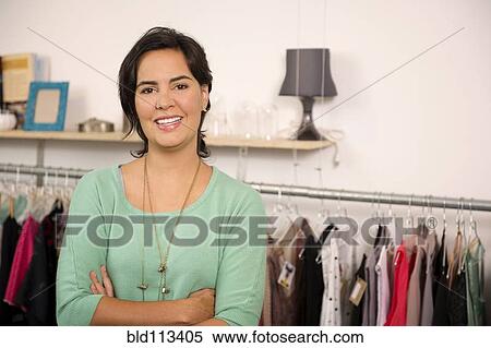 Hispanic woman smiling in shop View Large Photo Image Stock Photography - Hispanic woman smiling in shop. Fotosearch