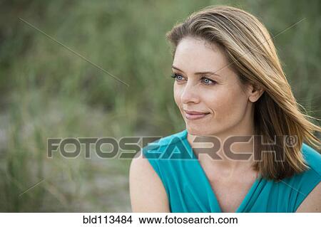 Picture - Hispanic woman smiling outdoors. Fotosearch