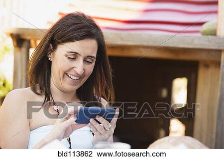 Hispanic woman using cell phone View Large Photo Image Stock Image - Hispanic woman using cell phone. Fotosearch