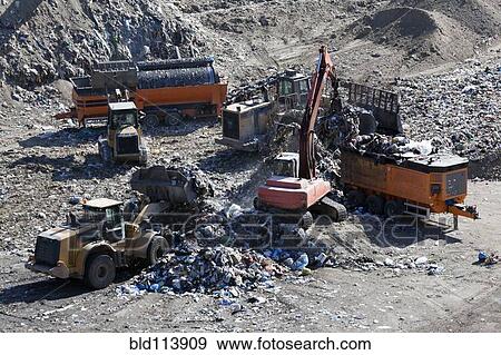 Machinery working in landfill View Large Photo Image Stock Photo - Machinery working in landfill. Fotosearch