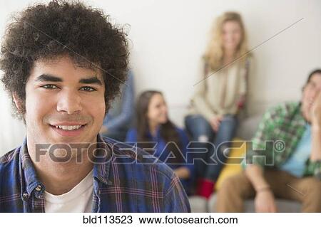 Stock Image - Man smiling in living room. Fotosearch