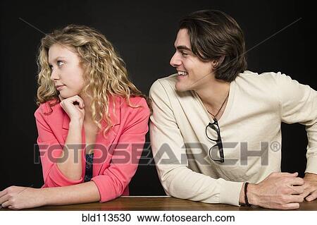 Stock Image - Man talking to uninterested woman. Fotosearch