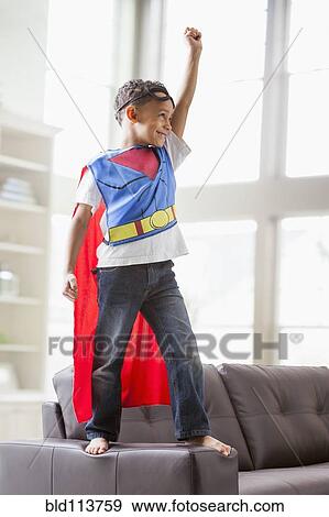 Mixed race boy playing superhero View Large Photo Image Stock Photo - Mixed race boy playing superhero. Fotosearch