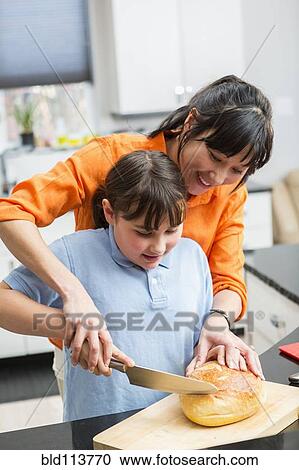 Mother and daughter cooking together View Large Photo Image Stock Image - Mother and daughter cooking together. Fotosearch