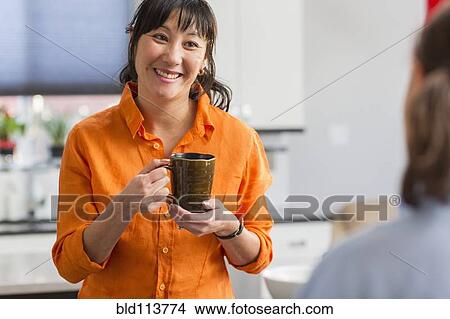 Mother and daughter talking in kitchen View Large Photo Image Picture - Mother and daughter talking in kitchen. Fotosearch