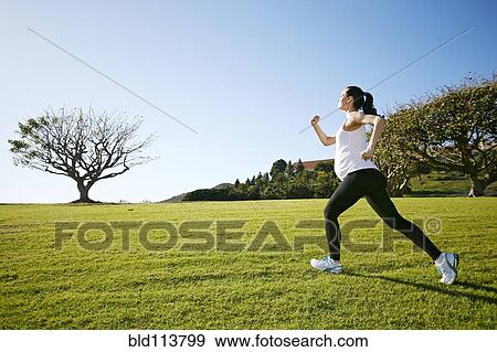 Pregnant mixed race woman jogging in field View Large Photo Image Stock Photo - Pregnant mixed race woman jogging in field. Fotosearch