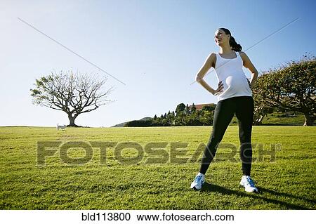 Pregnant mixed race woman standing in field View Large Photo Image Stock Image - Pregnant mixed race woman standing in field. Fotosearch