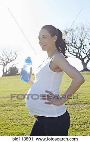 Pregnant mixed race woman standing in field View Large Photo Image Stock Image - Pregnant mixed race woman standing in field. Fotosearch