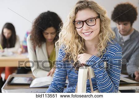 Student smiling in class View Large Photo Image Stock Image - Student smiling in class. Fotosearch