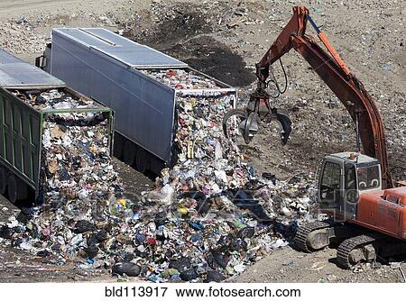 Trucks dumping refuse into landfill View Large Photo Image Stock Photo - Trucks dumping refuse into landfill. Fotosearch