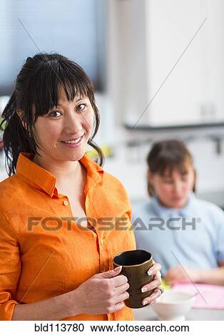 Woman having cup of coffee in kitchen View Large Photo Image Stock Image - Woman having cup of coffee in kitchen. Fotosearch