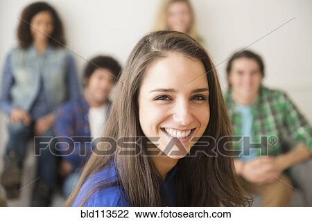 Stock Image - Woman smiling in living room. Fotosearch