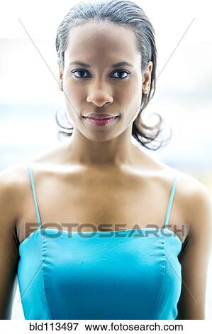 Stock Photo - Woman standing indoors. Fotosearch