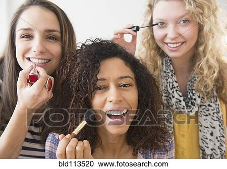 Women applying makeup together View Large Photo Image Stock Image - Women applying makeup together. Fotosearch