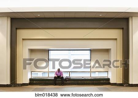 Stock Photo - African American businessman sitting on bench. Fotosearch
