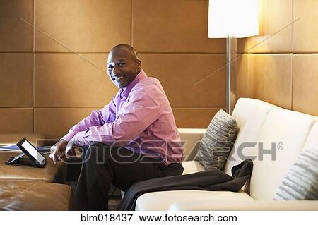 Stock Photo - African American businessman using tablet computer. Fotosearch