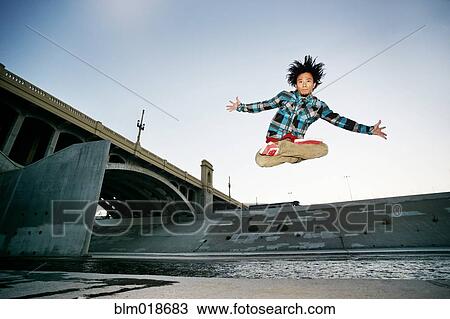 Asian man break dancing under overpass View Large Photo Image Stock Image - Asian man break dancing under overpass. Fotosearch