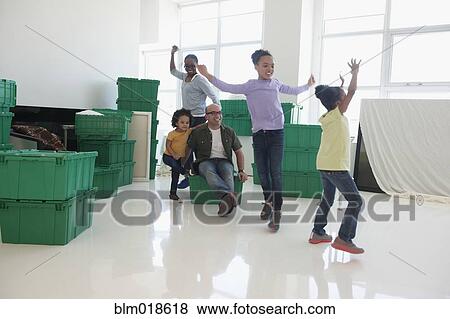 Stock Photo - Black family playing in new home. Fotosearch