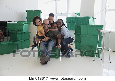Black family smiling in new home View Large Photo Image Stock Photo - Black family smiling in new home. Fotosearch