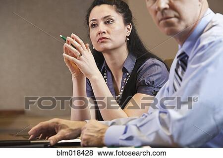 Business people listening in meeting View Large Photo Image Stock Photo - Business people listening in meeting. Fotosearch