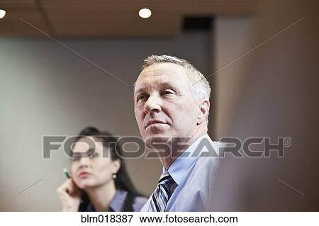 Business people sitting in meeting View Large Photo Image Stock Photo - Business people sitting in meeting. Fotosearch