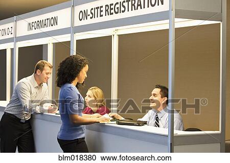 Stock Image - Business people talking at booths. Fotosearch