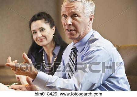 Stock Photo - Business people talking in meeting. Fotosearch