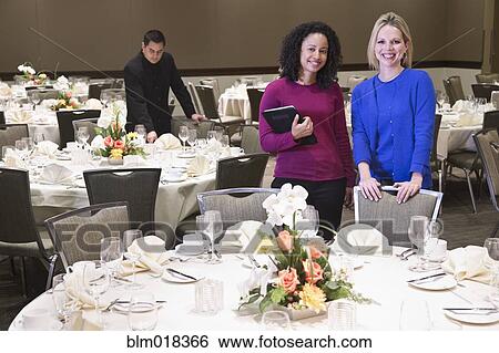 Stock Photograph - Businesswomen smiling in dining room. Fotosearch