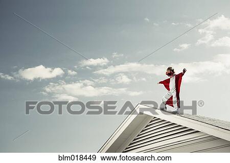 Caucasian boy in cape at edge of roof View Large Photo Image Stock Photo - Caucasian boy in cape at edge of roof. Fotosearch