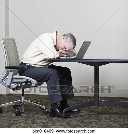 Stock Photo - Caucasian businessman sleeping on laptop. Fotosearch