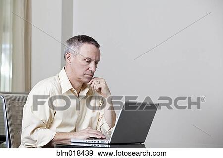 Caucasian businessman using laptop View Large Photo Image Stock Photo - Caucasian businessman using laptop. Fotosearch