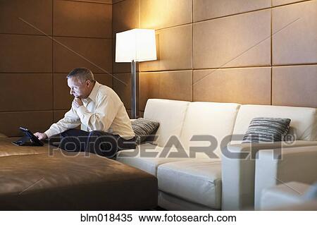 Stock Photography - Caucasian businessman using tablet computer. Fotosearch