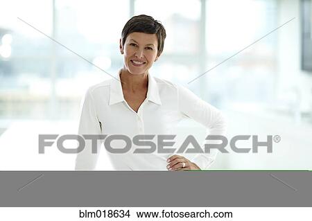 Picture - Caucasian businesswoman smiling in office. Fotosearch