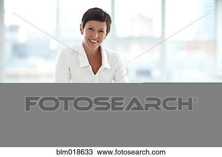 Caucasian businesswoman smiling in office View Large Photo Image Stock Image - Caucasian businesswoman smiling in office. Fotosearch