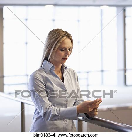 Picture - Caucasian businesswoman using cell phone. Fotosearch