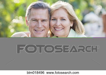 Caucasian couple hugging outdoors View Large Photo Image Stock Photograph - Caucasian couple hugging outdoors. Fotosearch