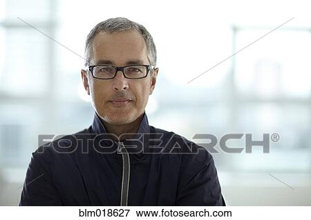 Stock Photo - Caucasian man smiling in office. Fotosearch
