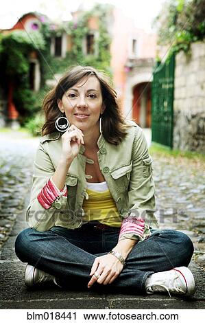 Caucasian woman sitting on city street View Large Photo Image Stock Image - Caucasian woman sitting on city street. Fotosearch