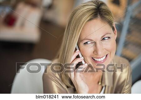 Stock Image - Caucasian woman talking on cell phone. Fotosearch