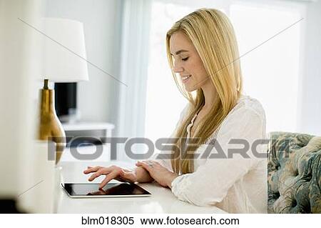 Stock Photography - Caucasian woman using tablet computer. Fotosearch