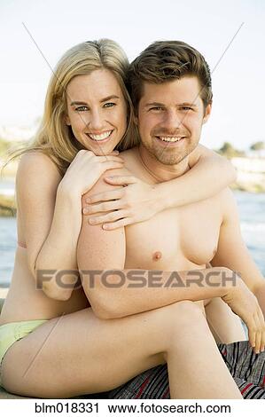 Couple hugging on beach View Large Photo Image Stock Image - Couple hugging on beach. Fotosearch