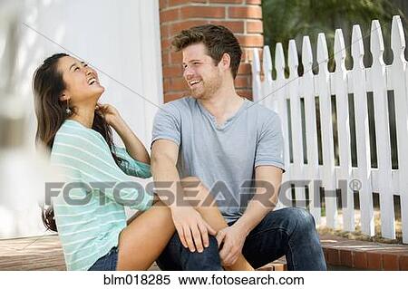 Stock Photography - Couple laughing together outdoors. Fotosearch