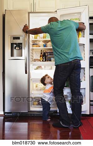 Father and baby looking through fridge View Large Photo Image Stock Image - Father and baby looking through fridge. Fotosearch