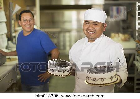 Hispanic baker smiling in kitchen View Large Photo Image Stock Photograph - Hispanic baker smiling in kitchen. Fotosearch