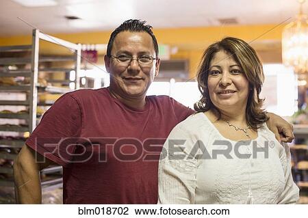 Hispanic bakers smiling in kitchen View Large Photo Image Stock Image - Hispanic bakers smiling in kitchen. Fotosearch
