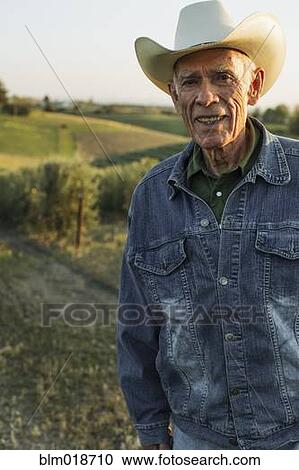 Hispanic farmer standing in vineyard View Large Photo Image Stock Image - Hispanic farmer standing in vineyard. Fotosearch